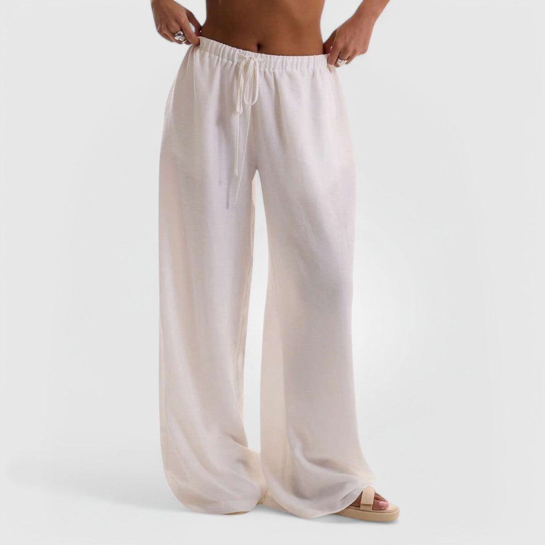White Relaxed Linen Pants with wide-leg fit, elastic waistband, and breathable fabric for comfortable everyday wear.