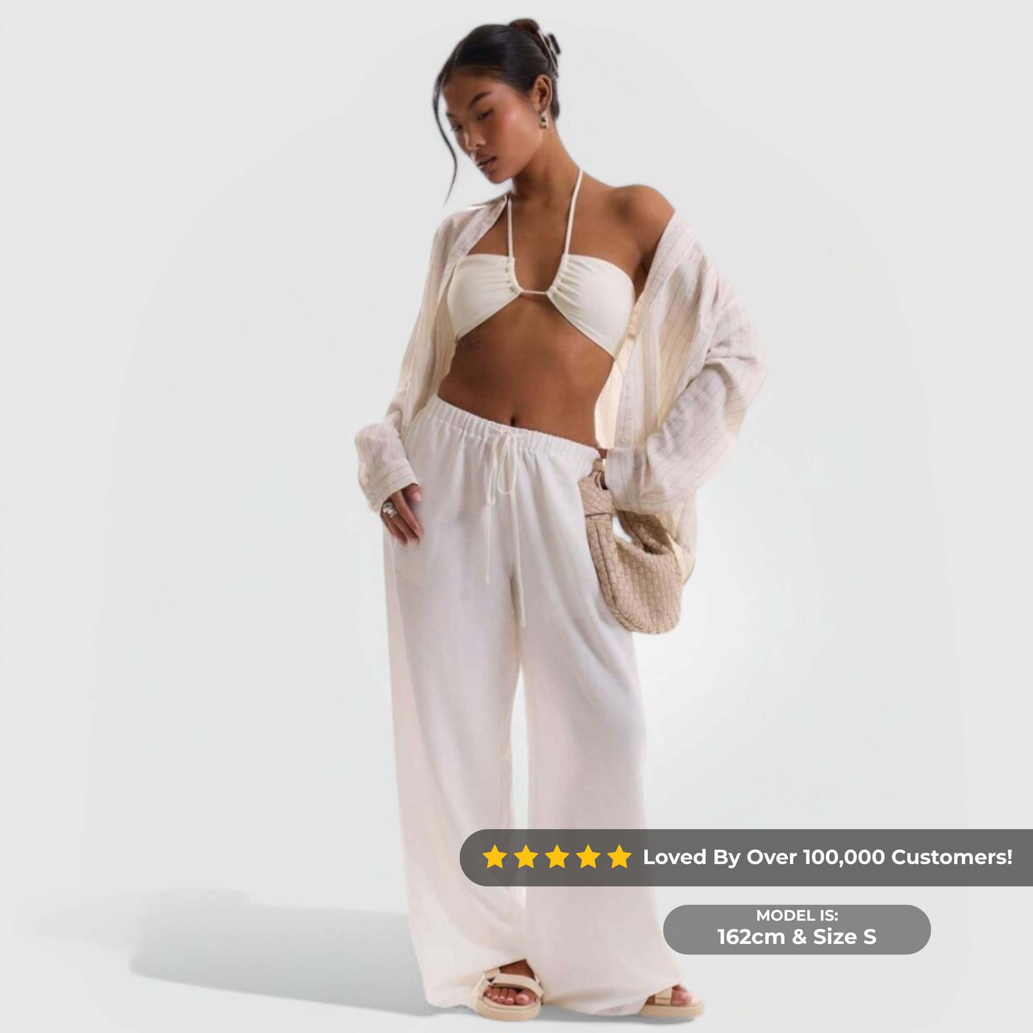 Relaxed Linen Pants - White worn by model, featuring wide-leg fit and elastic waistband for casual, breathable comfort.