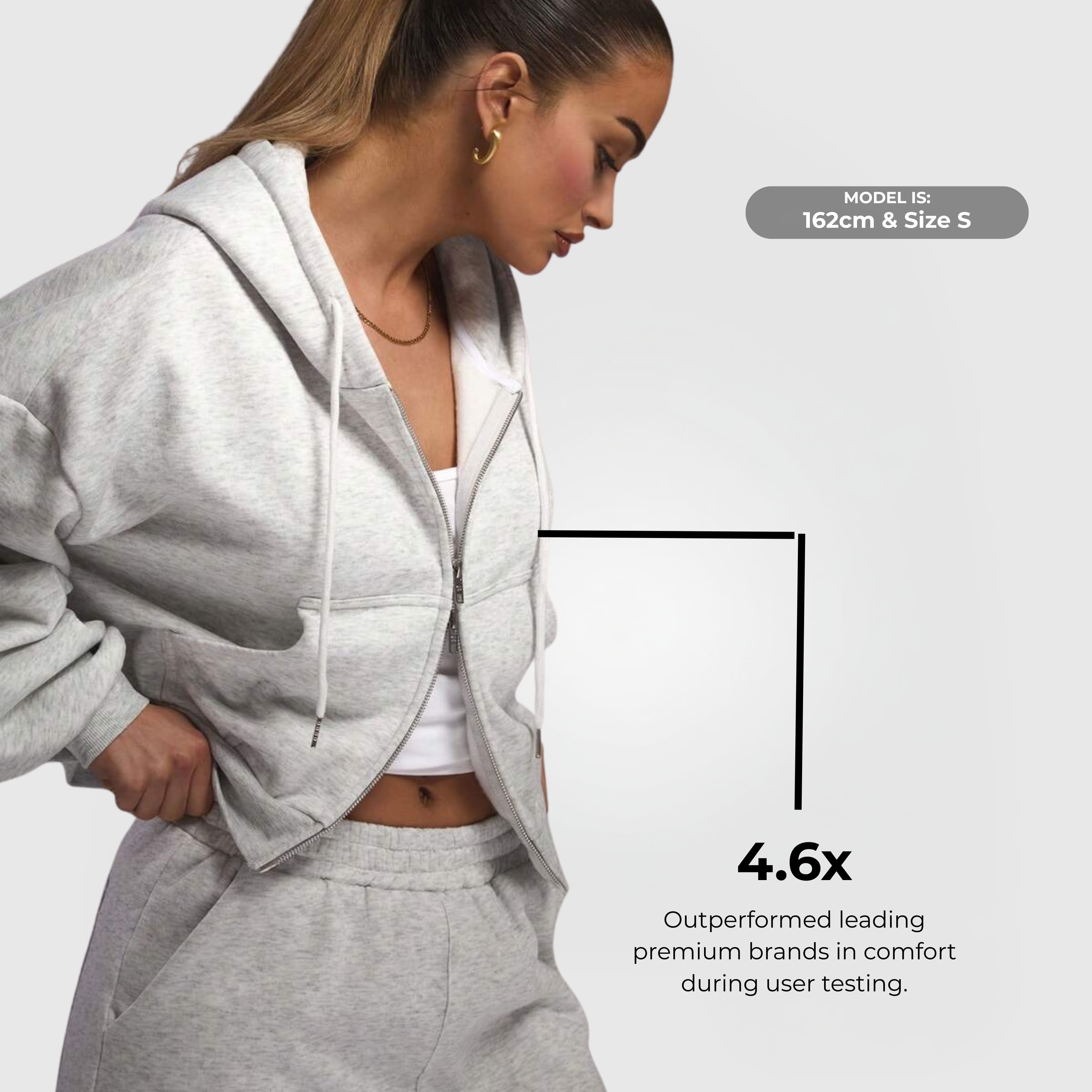 Comfort Zip Hoodie – Grey worn by a model, featuring a zip-up front, drawstring hood, and tailored fit in soft fabric.
