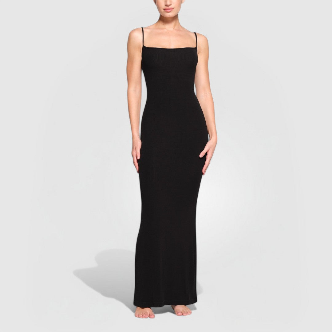 Model wearing a black Sculpting Maxi Dress with thin straps and a body-hugging silhouette.