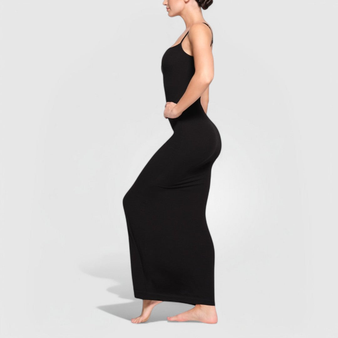 Woman wearing a sleek, body-hugging Sculpting Maxi Dress – Black with thin straps and maxi length.