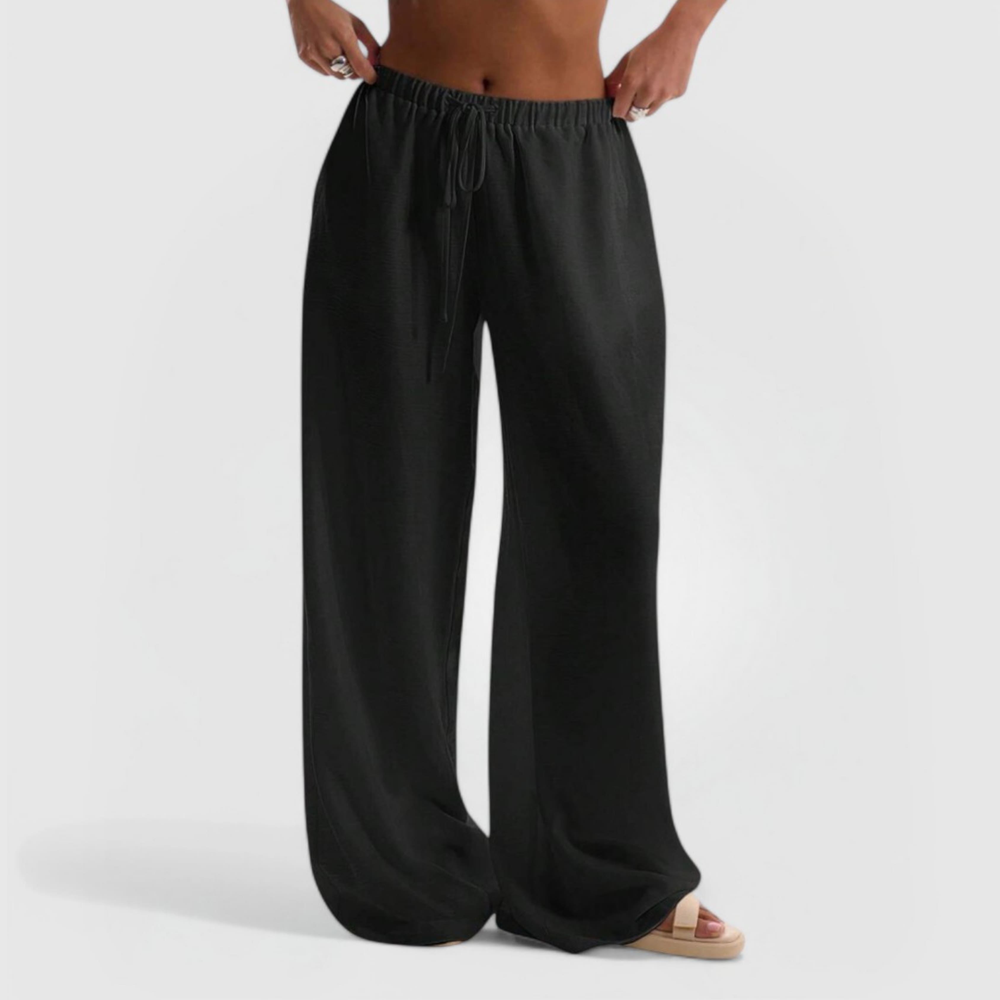 Model wearing black wide-leg Relaxed Linen Pants with elastic waistband and drawstring against white background