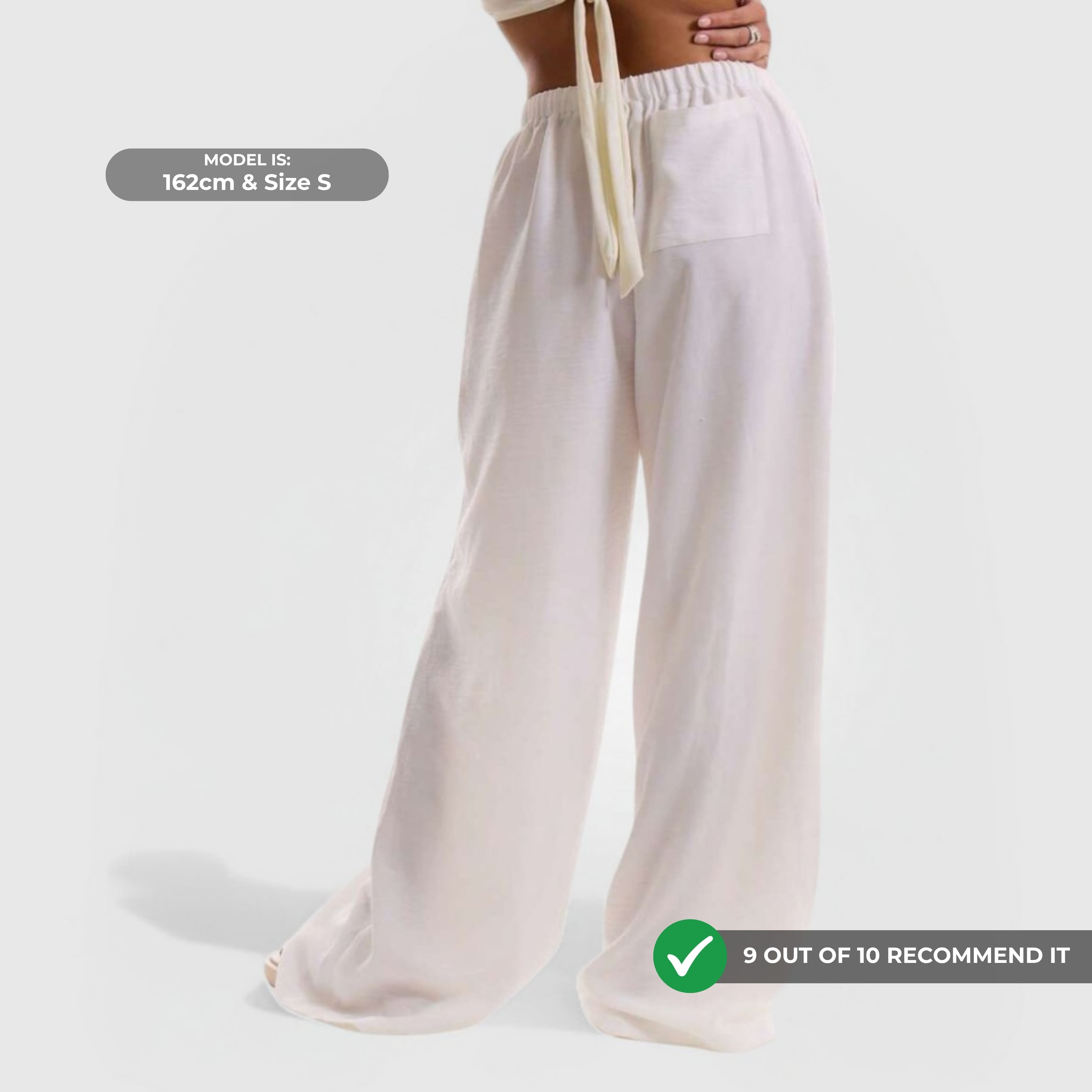 Relaxed Linen Pants - White shown in wide-leg style with elastic waistband and breathable fabric on model.