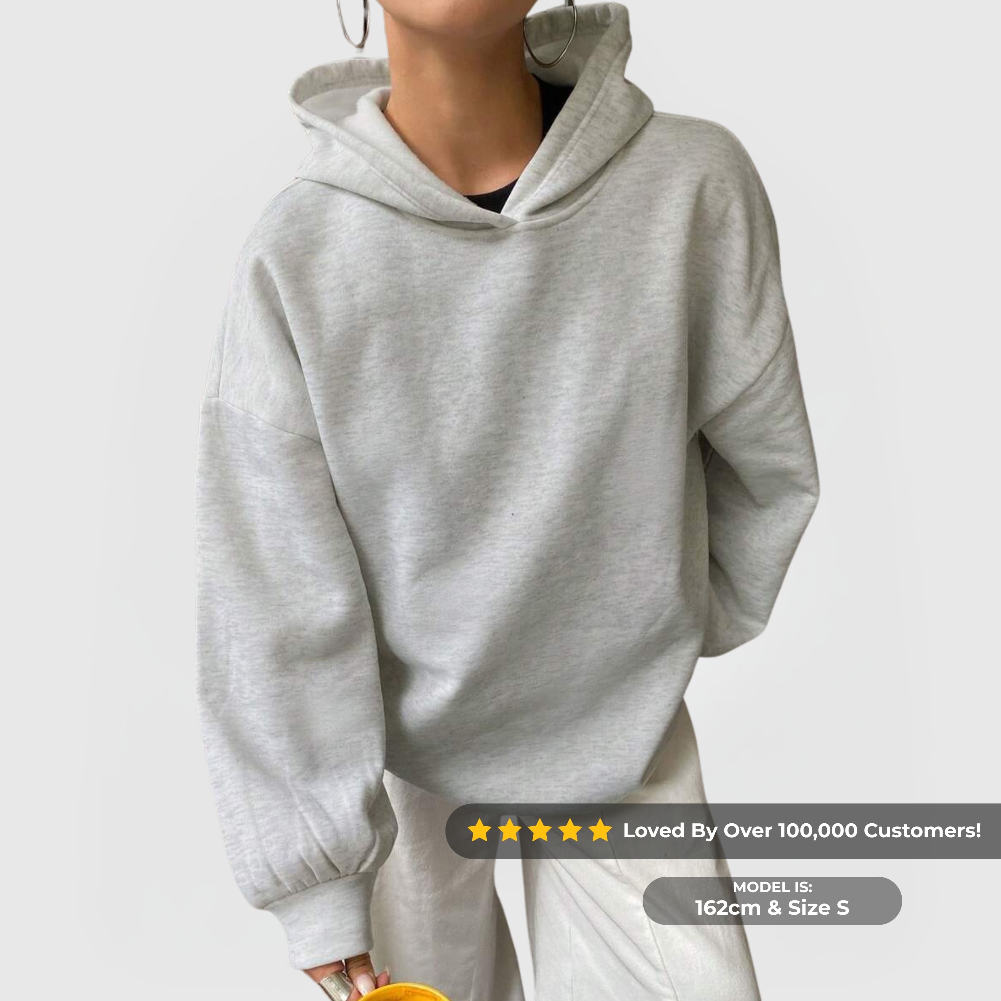 Model wearing the Oversized Essential Hoodie – Grey with dropped shoulders and relaxed fit, styled casually.